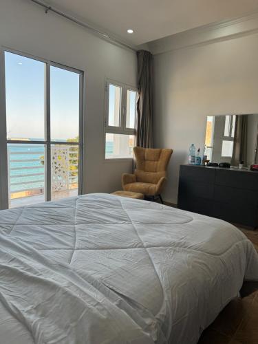 um quarto com uma cama grande e uma cadeira em Muttrah Souq and Sea View em Mascate
