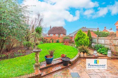 a home with a yard with a lawn with plants at TAYLOR DRIVE by BOURNECOAST - A Lovely Countryside Family Home with a Garden and Parking - HB1522 in Bournemouth