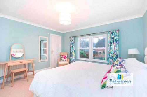 a bedroom with a bed and a desk and a window at TAYLOR DRIVE by BOURNECOAST - A Lovely Countryside Family Home with a Garden and Parking - HB1522 in Bournemouth