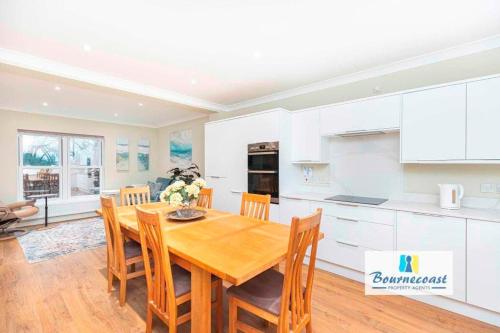 a kitchen and dining room with a wooden table and chairs at TAYLOR DRIVE by BOURNECOAST - A Lovely Countryside Family Home with a Garden and Parking - HB1522 in Bournemouth