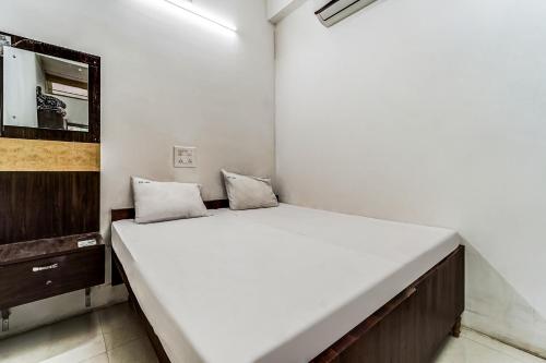 a bedroom with a large white bed in a room at Solar Inn in Tirupati