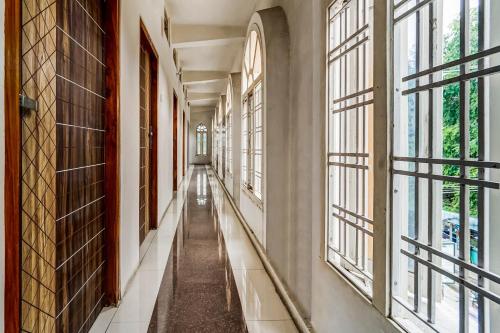 an empty corridor with windows in a building at Solar Inn in Tirupati