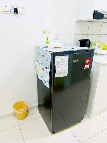 a refrigerator in a kitchen with a table on top at C&Y Horizon Suites Homestay Sepang - KLIA Transit - Near XiaMen University in Kampong Melot