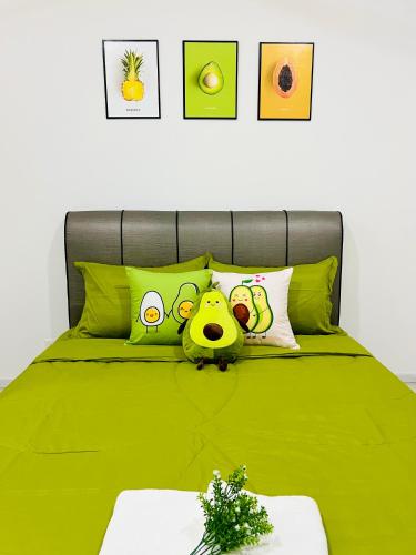 a green bed with a cartoon face on it at C&Y Horizon Suites Homestay Sepang - KLIA Transit - Near XiaMen University in Kampong Melot