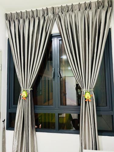 a window with gray curtains in a room at C&Y Horizon Suites Homestay Sepang - KLIA Transit - Near XiaMen University in Kampong Melot