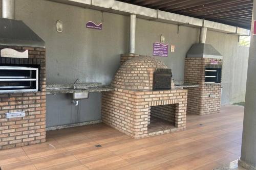 an outdoor brick oven in a patio at Apartamento bossa nova in Aracaju