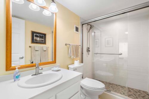 a bathroom with a sink and a toilet and a shower at White Sands Village#213 in Kailua-Kona