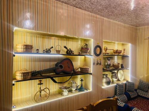 a room with shelves with a guitar and other items at THE GULMARG PALACE in Gulmarg