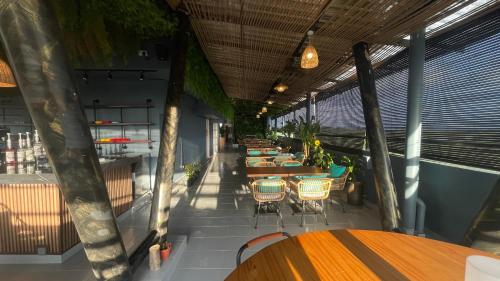 a restaurant with tables and chairs on a balcony at Sunflower World Hotel in Kuala Selangor