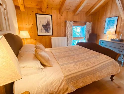 a bedroom with a bed in a wooden room at Chalet La Grange in Seytroux