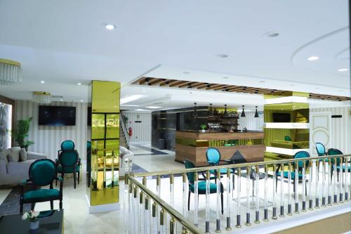 a living room with blue chairs and a staircase at UNITED HOTEL INTERNATIONAL in Yaoundé