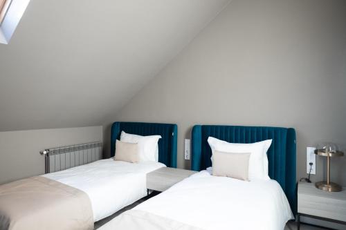 two beds sitting next to each other in a room at R.HOTEL in Chernivtsi