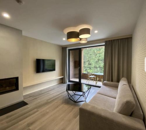 a living room with a couch and a television at Apartmán Alenka in Bystrá