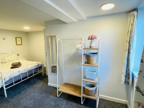 a room with a bed and a bunk bed at 10 Bromleys Court in Church Stretton