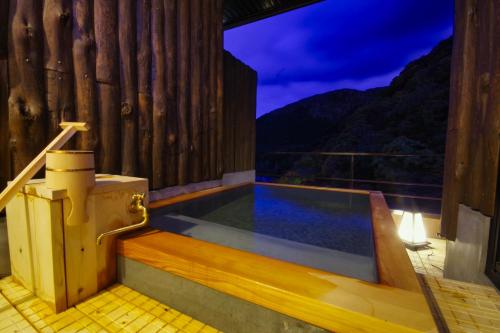 a swimming pool in a wooden house with a toilet at Yuze Hotel in Kazuno