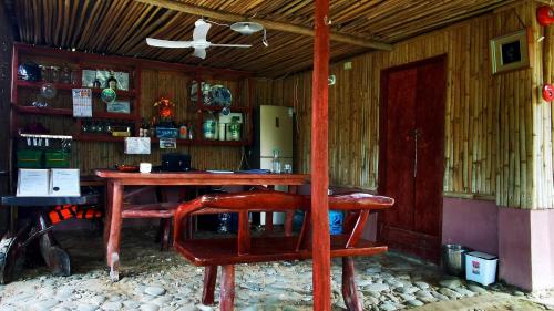 a room with a wooden table and a chair at Dreamer Resort in San Vicente