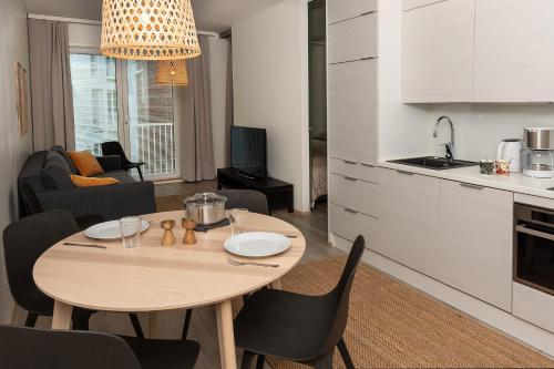 a kitchen and living room with a table and chairs at Holiday Apartment Aava 2 in Rovaniemi
