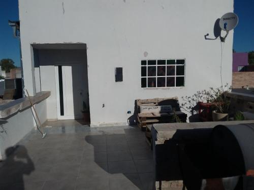 a living room with a white wall and a window at Lupita 3 in General Roca