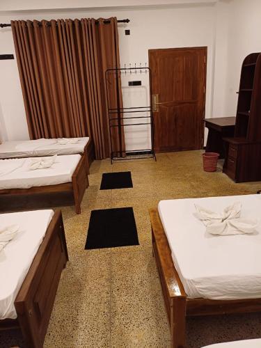 a room with two beds and a radiator at World's End Base Eco-Village in Belihul Oya