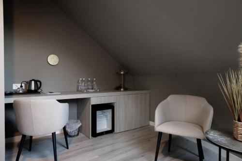 a living room with two chairs and a fireplace at R.HOTEL in Chernivtsi