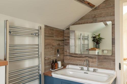 a bathroom with a sink and a mirror at White House, Port Isaac Bay Holidays in Port Isaac