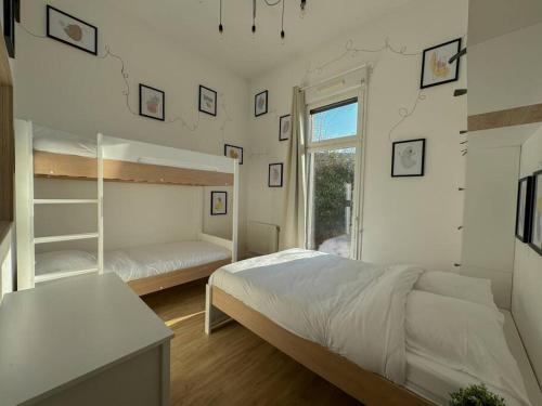a bedroom with two bunk beds and a window at Mon refuge magique à Disneyland in Chanteloup-en-Brie