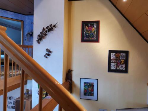 a staircase with some pictures on the wall at Ferienwohnung Yuan in Bruchweiler-Bärenbach