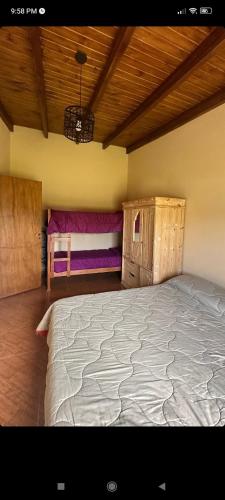 a bedroom with a large bed and wooden cabinets at LA QUINTA DE LOLI in San Pedro