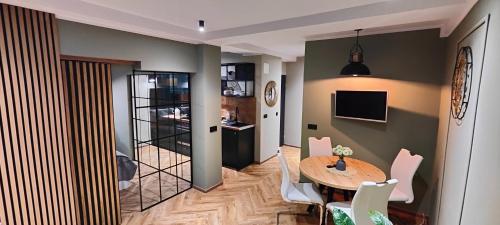 a dining room with a table and chairs at Apartament Korfantego 30 in Katowice