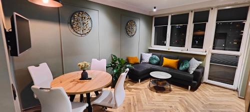 a living room with a couch and a table at Apartament Korfantego 30 in Katowice