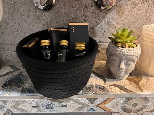 a basket of wine bottles sitting on a counter at Apartament Korfantego 30 in Katowice