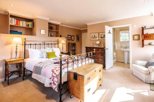 a bedroom with a bed and a desk and a chair at 29 Wentworth Road, Aldeburgh in Aldeburgh