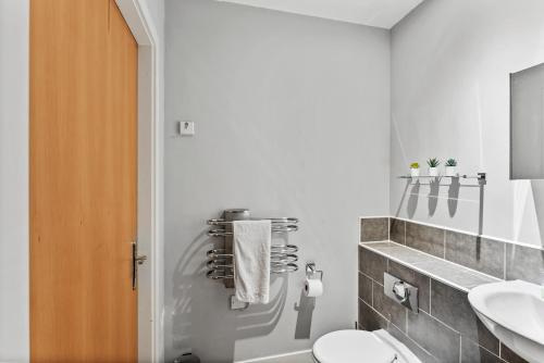 a white bathroom with a toilet and a sink at Lovely Yorkshire Duplex - Sleeps 6 - Netflix in Dewsbury