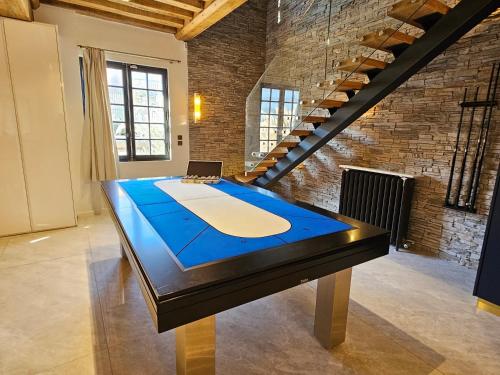 a ping pong table in the middle of a room at Villa d'exception, 5 chambres, 20m plage, spa. in Bénerville-sur-Mer