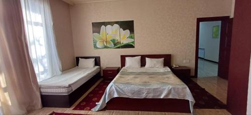 a hotel room with two beds and a window at Gabala Bliss Inn Hotel and Restaurant in Gabala