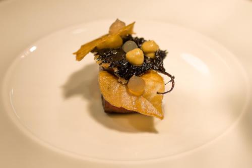 a white plate with a piece of food on it at Collina Luxury Relais in Clusone