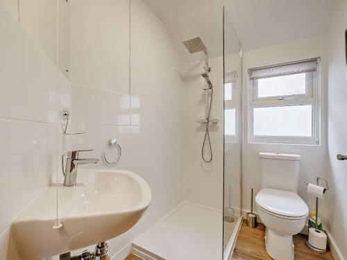 a white bathroom with a sink and a toilet at 2 Bed in Aberdovey 91962 in Aberdyfi