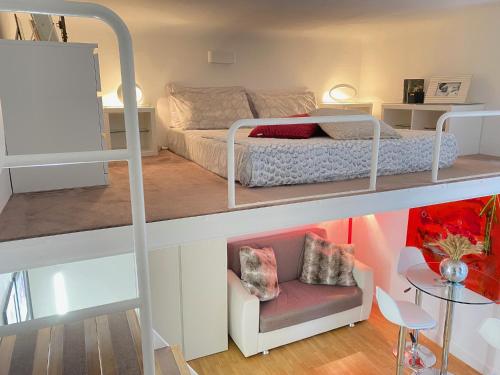 a room with a bunk bed and a couch at Monolocale Morimondo 1 in Milan