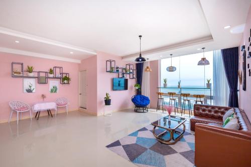 a living room with a couch and a table at Căn Hộ "2" OaSky View biển 3 Phòng 5 Giường- Oasky Sea View Apartment in Vung Tau