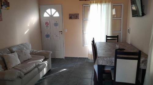 a living room with a couch and a table at Casa Passiflora II in Villa Elisa