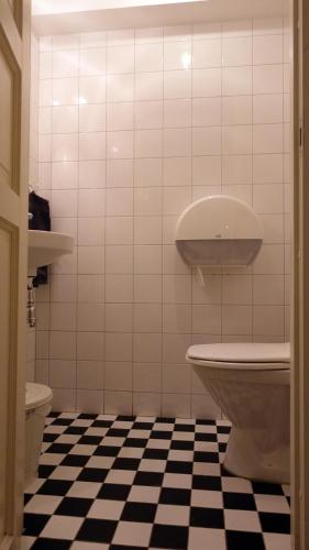 a bathroom with a black and white checkered floor at City Backpackers Hostel in Stockholm