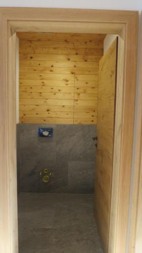 an open door to a room with a wooden wall at Ferienhaus & -wohnung Flatscher in Waidring
