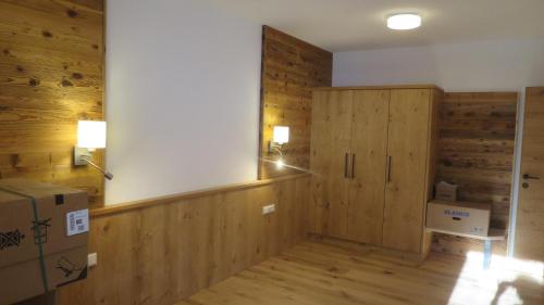 a room with wooden walls and a room with boxes at Ferienhaus & -wohnung Flatscher in Waidring