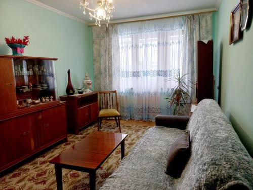 ein Wohnzimmer mit einem Sofa und einem Tisch in der Unterkunft Apartments in Lviv in Lwiw