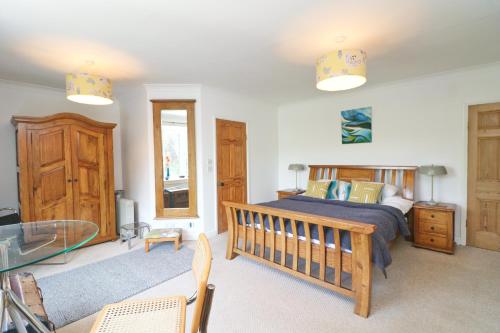 a bedroom with a bed and a glass table at Beautiful character cottage in Saint Mawgan