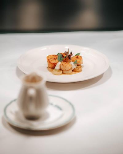 a plate of food on a white table at City of Dreams Mediterranean - Integrated Resort, Casino & Entertainment in Limassol