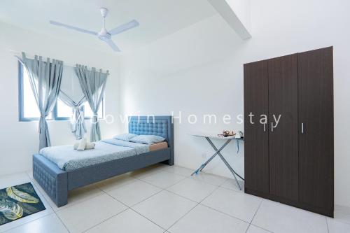 a bedroom with a bed and a desk in a room at Cozy&Comfy Suite Room Perai in Perai