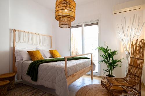 a bedroom with a bed and a potted plant at Piraeus Urban Gem in Piraeus