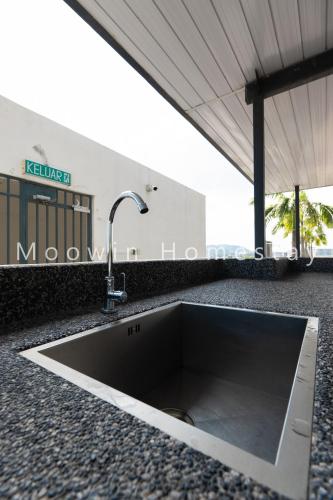 a sink in the middle of a counter at Cozy&Comfy Suite Room Perai in Perai