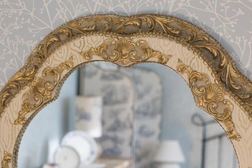 an ornate gold mirror in a living room at Villa Rosa in Dunajská Streda